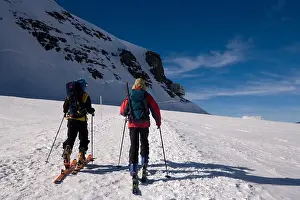 Two people glacier hiking at Jungfraufirn glacier to Moenchsjoch Hut (3650 m highest restaurant in the Swiss Alps)