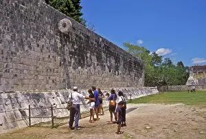 Yucatan Peninsula Prints: People standing below ancient Mayan Ballgame Hoop in Chichen Itza sport court