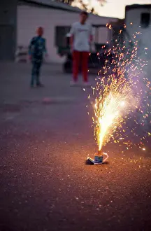 30 To 35 Years Prints: Two people watching fireworks go off on a driveway