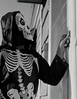 Trick Or Treat Prints: Person ringing doorbell wearing as skeleton