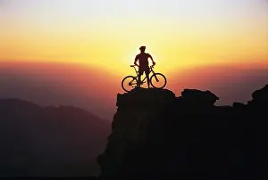 Bicycle Prints: A person standing on the summit with his mountainbike, Andalusia, Spain