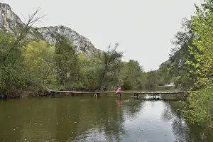 Fresh Air Prints: Person walking on wooden bridge over calm water surrounded by trees