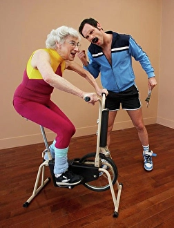 Standing Up Prints: Personal Trainer Encouraging Woman on Exercise Bike