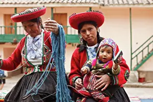 Communications Prints: Peru, Indigenous People, Mother and baby in traditional dress with a lady making yarn and infant holding mobile phone