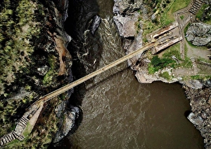 Route Prints: Peru, Quehue, aerial view of woman crossing rope bridge