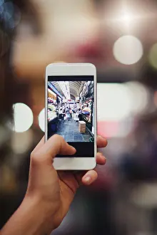 Cellphone Prints: Phone, screen and hands of person take picture in city for night market