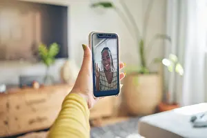 Conversation Prints: Phone, wave and black woman on video call in portrait