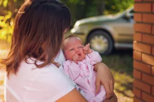 People In Nature Prints: Photo of a mother holding her newborn baby daughter close