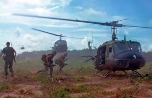 Helicopter Prints: Photograph of American troops running towards a chopper during the Vietnam War. Dated 1970