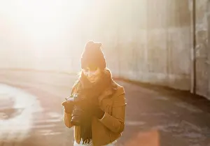 Lens Flare Prints: Photographer bathed in golden hour light captures the perfect shot