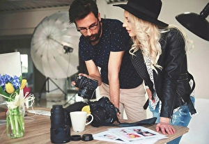 Consumer Electronics Prints: Photographer and stylist reviewing photographs on photography studio camera