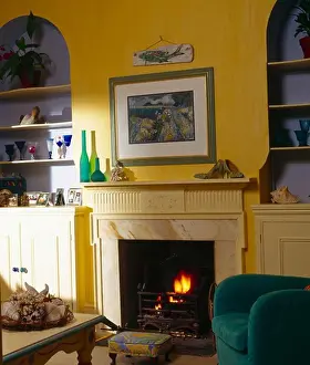Picture Prints: Picture above fireplace in yellow living room with blue alcoves