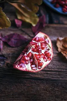 Rustic Prints: Piece of pomegranate on a rustic wooden table