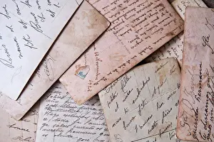 Manuscript Prints: pile of old handwritten letters scattered on the table