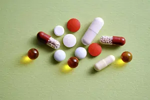 Tablet Prints: Pills, vitamins and dietary supplements on a green background. High quality photo