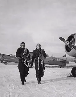 Aviation Prints: Pilots in the 1950s. Two pilots are walking past fighter aircraft a winter day