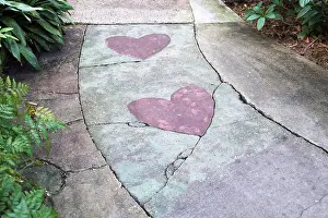 Florida Prints: Pink heart shapes embedded in the surface of a walkway