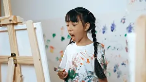 Stained Prints: Playful student painted or draw canvas at stained wall in art lesson