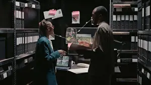 Case Prints: Police agents examining criminal records in incident room