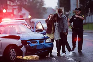 Heroes Prints: Police officer on scene of automobile accident escorting three injured young adults to safety