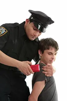 Arbeiten Prints: Police officer with teen uvenile delinquent A policeman with a male juvenile delinquent that has stolen an electronic
