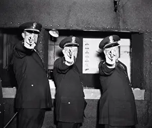 Early 1900s Prints: Three police officers pointing their guns (revolvers) at the photographer circa 1936