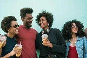 Diverse Prints: Portrait of afro friends having fun together and enjoying good time while drinking fresh fruit juice