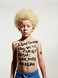 Activism Prints: Portrait of Albino boy with words painted on body I love pandas