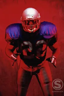 Contrast Prints: Portrait of an American football player standing in a tackle pose