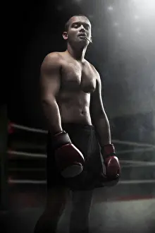 Macho Prints: Portrait of attractive boxer in the dark