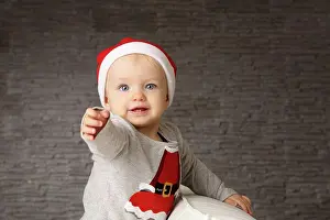 Upper Body Prints: Portrait of baby girl wearing Christmas cap