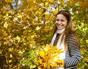 With Each Other Prints: Portrait of a beautiful teenage girl having fun in autumn park.Outdoor