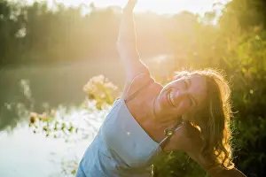 Mature Adult Prints: Portrait of a beautiful woman laughing hysterically by river, Germany, Bavaria