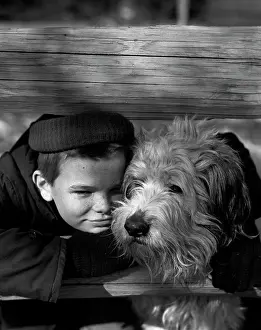 Adolescence Prints: Portrait of boy with dog