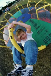 One Child Only Prints: Portrait of a boy on a merry-go-round
