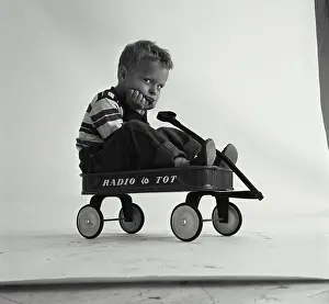 Capital Prints: Portrait of a boy sitting in a wagon