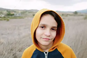 Hike Prints: Portrait Of A Boy Wearing An Orange Hoodie Outside In Nature