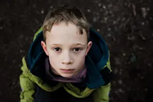 Attractive Prints: portrait of a serious brown eyed boy looking up
