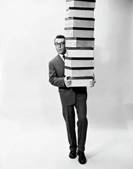 Business Suit Prints: Portrait of a businessman carrying a stack of boxes