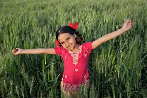 4 5 Years Prints: Portrait of a carefree little girl standing with arms out in a wheat field