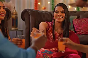 Occasion Prints: Portrait of cheerful woman celebrating Diwali at home with her friends