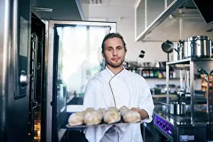Self Employed Prints: Portrait of chef baking breads in commercial kitchen