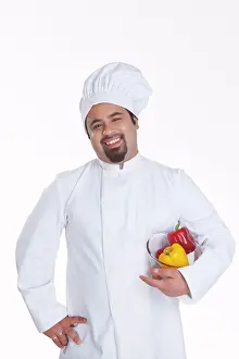 Crockery Prints: Portrait of chef with bowl of capsicum