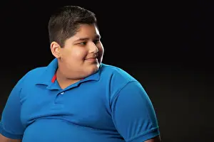 Overweight Prints: Portrait of a chubby boy looking sideways. (Obesity)