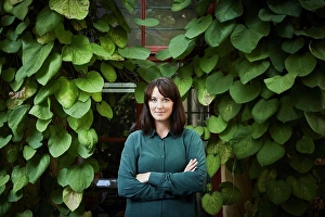 Business And Occupation Prints: Portrait of confident female architect standing against creeper plants in backyard