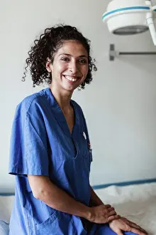 Doctors Prints: Portrait of confident female doctor sitting in medical clinic
