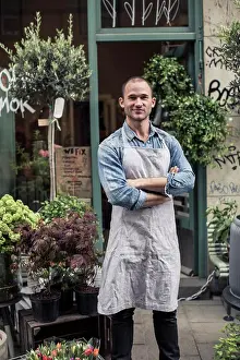 Entrances Prints: Portrait of confident male florist standing arms crossed outside flower shop
