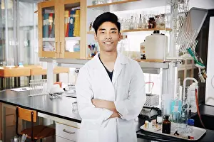 Instruction Prints: Portrait of confident young male university student standing with arms crossed at chemistry laboratory