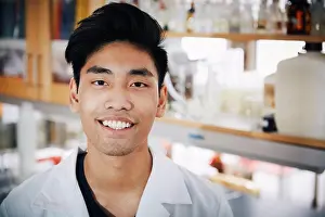 Instruction Prints: Portrait of confident young male university student standing at chemistry laboratory