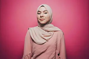 Expressions Prints: Portrait of confident young woman wearing hijab against pink background